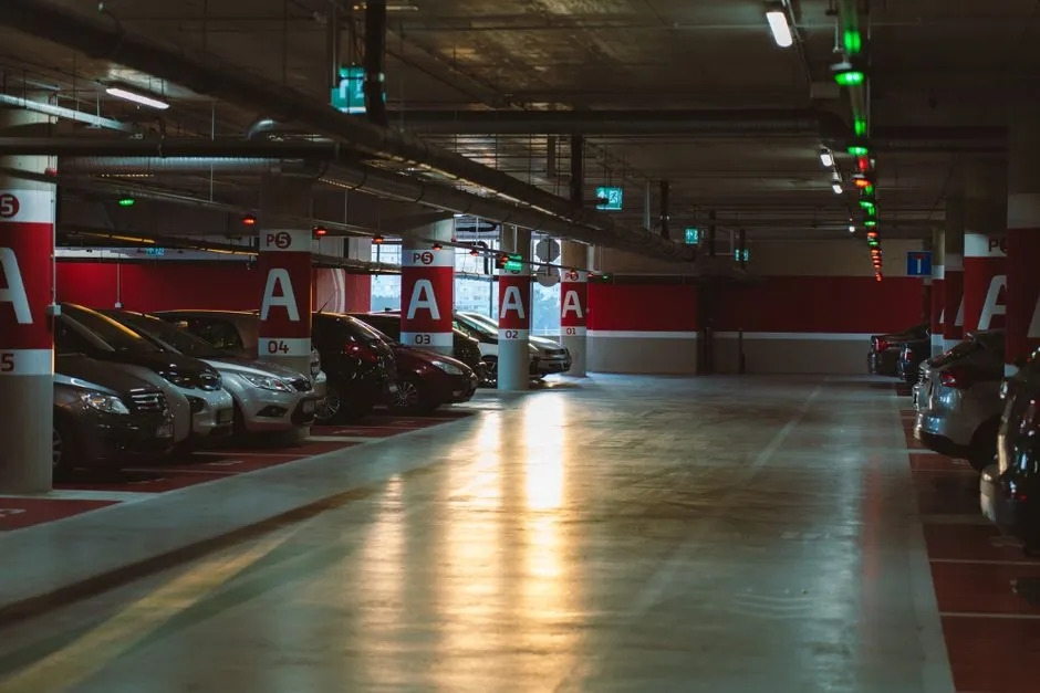 Cars parked on a level of a multi-story airport parking garage